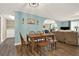 View of dining area with table, bench, and chairs, with washer/dryer room in the background at 3653 Memorial Nw Pkwy, Kennesaw, GA 30152