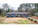 Charming single-story home with a blue exterior, wooden shutters, and a well-maintained front yard at 3653 Memorial Nw Pkwy, Kennesaw, GA 30152