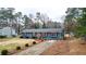 View of house featuring the blue exterior paint, driveway, trees, and well-maintained front yard at 3653 Memorial Nw Pkwy, Kennesaw, GA 30152