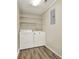 Convenient laundry area with modern washer and dryer, plus storage shelves at 3653 Memorial Nw Pkwy, Kennesaw, GA 30152