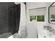 Modern bathroom featuring a tiled shower, sleek fixtures, and a window with a view of the outdoors at 3306 Briarcliff Ne Rd, Atlanta, GA 30345
