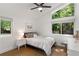 Bright bedroom with large windows offering views of lush greenery, hardwood floors, and a ceiling fan at 3306 Briarcliff Ne Rd, Atlanta, GA 30345