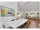 Open concept dining room with a white table and stylish chairs beneath a modern, colorful art piece at 3306 Briarcliff Ne Rd, Atlanta, GA 30345
