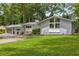 Charming, gray painted brick home with a well-manicured lawn and a large window accent at 3306 Briarcliff Ne Rd, Atlanta, GA 30345