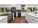 Contemporary kitchen with white cabinets, stainless steel appliances, and hardwood flooring at 3306 Briarcliff Ne Rd, Atlanta, GA 30345