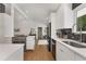 Modern kitchen with stainless steel appliances, white countertops, and dark tile backsplash, open to living area at 3306 Briarcliff Ne Rd, Atlanta, GA 30345