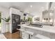 Bright modern kitchen features an island with seating, white cabinets, and stainless steel appliances at 3306 Briarcliff Ne Rd, Atlanta, GA 30345