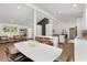 Open kitchen and dining area with white counters and cabinets, wood floors, and modern fixtures at 3306 Briarcliff Ne Rd, Atlanta, GA 30345