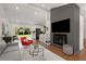 Open living space with a gray sofa, brick fireplace, and view of the backyard through sliding glass doors at 3306 Briarcliff Ne Rd, Atlanta, GA 30345