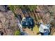 Aerial view showcases the property's roof, driveway, and surrounding trees at 4990 Sawgrass Nw Pl, Acworth, GA 30102