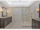 Bright bathroom with glass shower, double vanity, and tile flooring at 4990 Sawgrass Nw Pl, Acworth, GA 30102