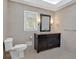 Bathroom featuring dark wood vanity with granite countertop, toilet, and tile flooring at 4990 Sawgrass Nw Pl, Acworth, GA 30102
