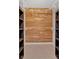Walk-in closet with wood-paneled walls and built-in shelving units at 4990 Sawgrass Nw Pl, Acworth, GA 30102