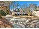 Elegant home with a long drive, mature trees, and a well-manicured lawn at 4990 Sawgrass Nw Pl, Acworth, GA 30102