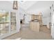 Bright kitchen featuring a large island, natural light, and adjacent living area with a fireplace at 4990 Sawgrass Nw Pl, Acworth, GA 30102