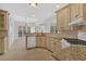 The U-shaped kitchen has a breakfast nook, granite counters, white appliances and tile flooring at 4990 Sawgrass Nw Pl, Acworth, GA 30102