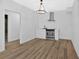 A bright kitchenette with stainless appliances, a stylish light fixture and wood-look vinyl flooring at 4990 Sawgrass Nw Pl, Acworth, GA 30102
