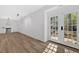 Bright living room features wood floors and a large glass door for natural light and easy outdoor access at 4990 Sawgrass Nw Pl, Acworth, GA 30102