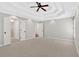 Spacious bedroom with neutral carpet and trey ceiling, with access to bathroom at 4990 Sawgrass Nw Pl, Acworth, GA 30102