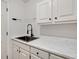 Mudroom with white cabinets, a countertop, a sink, and a door at 4990 Sawgrass Nw Pl, Acworth, GA 30102