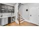 Wet bar near staircase with beverage fridge, cabinetry, and sleek countertops at 5006 Merton Ln, Marietta, GA 30068