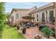 Outdoor patio features a brick surface, seating with a fire pit, lush green yard, and landscaping at 8025 Georgetown Cir, Suwanee, GA 30024