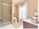 Bathroom with a glass-door shower, vanity with sink, and a toilet at 8025 Georgetown Cir, Suwanee, GA 30024