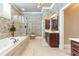 Primary bathroom features a soaking tub, shower, and spacious vanity at 8025 Georgetown Cir, Suwanee, GA 30024