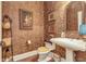 Powder room featuring patterned wallpaper, pedestal sink, and decorative accents at 8025 Georgetown Cir, Suwanee, GA 30024