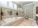 Primary bath showcasing a large soaking tub, tiled flooring, and natural light at 8025 Georgetown Cir, Suwanee, GA 30024