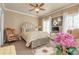 Comfortable bedroom with a cozy seating area and soft, natural light at 8025 Georgetown Cir, Suwanee, GA 30024