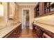 Long butler's pantry with granite counters, dark wood cabinetry, and recessed lighting at 8025 Georgetown Cir, Suwanee, GA 30024