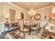 Elegant dining room with a chandelier, large windows, and a stylish table setting for formal occasions at 8025 Georgetown Cir, Suwanee, GA 30024