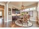 Cozy dining room featuring a chandelier, decorative artwork, and dark wood accents at 8025 Georgetown Cir, Suwanee, GA 30024