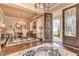 Formal dining room showcasing an elegant chandelier, hardwood flooring, and large windows for natural light at 8025 Georgetown Cir, Suwanee, GA 30024