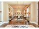 Sophisticated dining room featuring hardwood floors, chandelier, and neutral tones creating a refined ambiance at 8025 Georgetown Cir, Suwanee, GA 30024