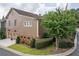 Side exterior of home with well-maintained lawn and attached two-car garage at 8025 Georgetown Cir, Suwanee, GA 30024