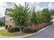 Exterior view of home featuring lush landscaping and two-car garage at 8025 Georgetown Cir, Suwanee, GA 30024