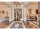 Grand foyer with hardwood floors, elegant chandelier, and view of formal areas, creating a welcoming entrance at 8025 Georgetown Cir, Suwanee, GA 30024