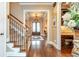 Welcoming foyer with hardwood floors, a staircase, and elegant double front doors at 8025 Georgetown Cir, Suwanee, GA 30024