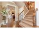 Open foyer area showcasing hardwood floors, staircase, and a glimpse into other rooms at 8025 Georgetown Cir, Suwanee, GA 30024