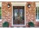 Elegant front entrance featuring a decorative double door with wrought iron accents and classic outdoor lighting at 8025 Georgetown Cir, Suwanee, GA 30024