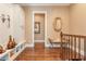 Upstairs hallway featuring wood floors and a built-in bench with shelving at 8025 Georgetown Cir, Suwanee, GA 30024