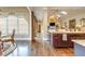 Open-concept kitchen, island, and breakfast nook, flowing into a bright living space at 8025 Georgetown Cir, Suwanee, GA 30024