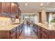 Spacious kitchen with granite countertops and modern appliances, flowing into a dining area with a chandelier at 8025 Georgetown Cir, Suwanee, GA 30024