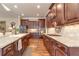 Large kitchen featuring custom cabinets, granite countertops, and stainless steel appliances at 8025 Georgetown Cir, Suwanee, GA 30024