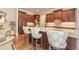 Bright kitchen featuring granite countertops, a large island with seating, and hardwood flooring at 8025 Georgetown Cir, Suwanee, GA 30024