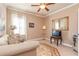 Cozy living room featuring neutral walls, patterned rug, and ceiling fan with light kit at 8025 Georgetown Cir, Suwanee, GA 30024