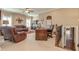 Living room area featuring leather seating, a desk, and carpet flooring at 8025 Georgetown Cir, Suwanee, GA 30024