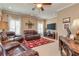 Living room area with leather seating, a TV, and a ceiling fan at 8025 Georgetown Cir, Suwanee, GA 30024